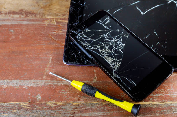 Broken smart phone and tablet on cracked touch screen process of mobile phone repair.